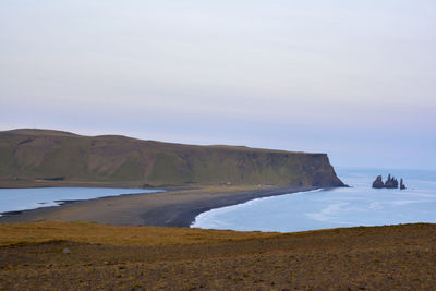 Scenic view of sea and mountains against sky