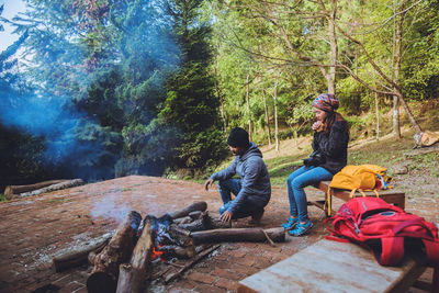 People sitting on land in forest