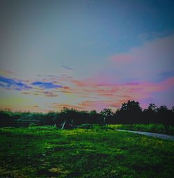 Scenic view of field against sky during sunset