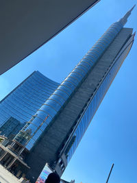Low angle view of modern buildings against clear blue sky