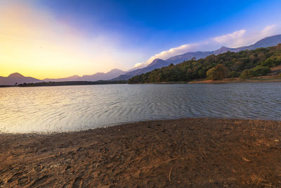 Scenic view of beach against sky during sunset
