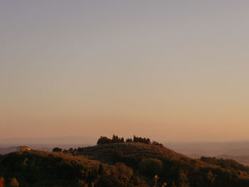 Scenic view of landscape against clear sky during sunset