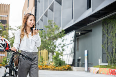 Portrait of young woman using mobile phone