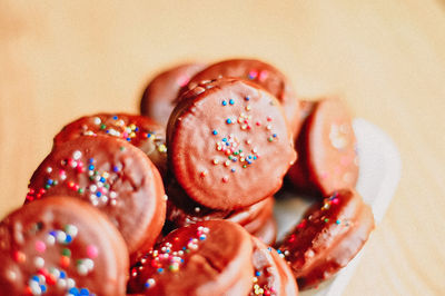 Gourmet chocolate covered oreos with colorful sprinkles on top.