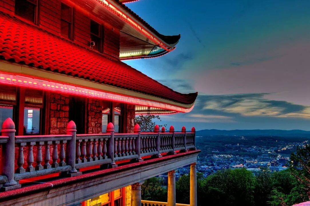 architecture, built structure, building exterior, sky, red, cloud - sky, sunset, city, travel destinations, famous place, cloud, dusk, outdoors, water, travel, tourism, railing, no people, mountain, illuminated