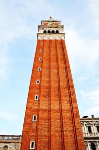 Low angle view of clock tower against sky in venice