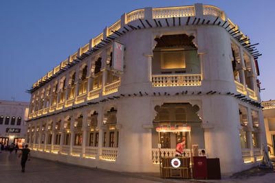 Illuminated building against sky in city