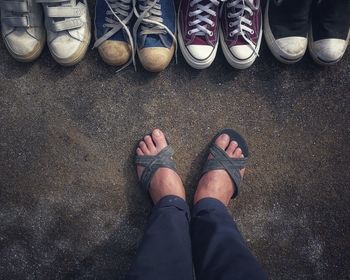 Low section of person standing by shoes