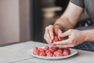 Midsection of man preparing food