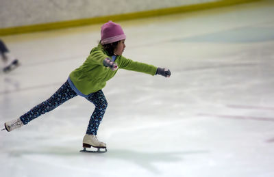 Low section of man skateboarding on snow