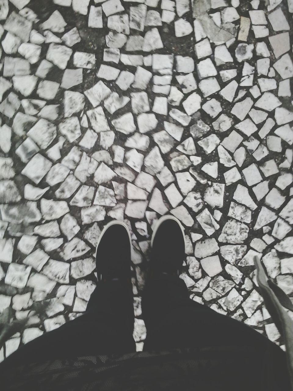 low section, person, standing, shoe, high angle view, lifestyles, men, cobblestone, personal perspective, unrecognizable person, pattern, leisure activity, paving stone, footpath, outdoors, human foot, directly above