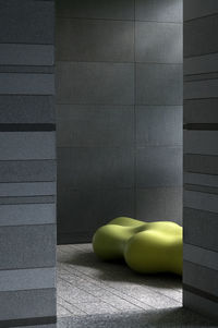 Low section of woman sitting on wall