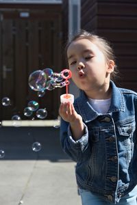 Happy girl standing at bubbles