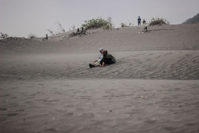 Man on beach against sky