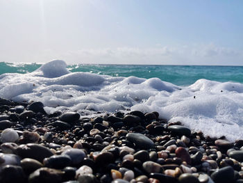 Rocks on beach against sky