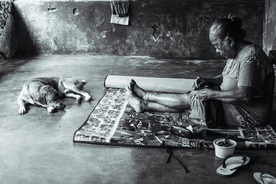 Man with dog sitting on deck chairs
