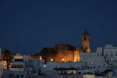 Buildings in city against clear sky