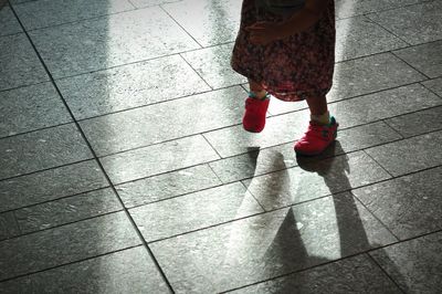 Woman standing on footpath