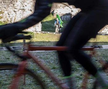 Low section of people on bicycle