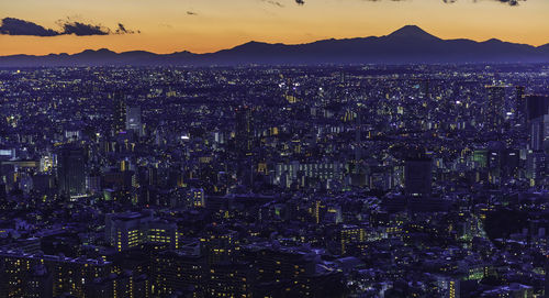 Aerial view of illuminated city buildings at night