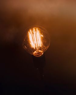 Close-up of illuminated light bulb