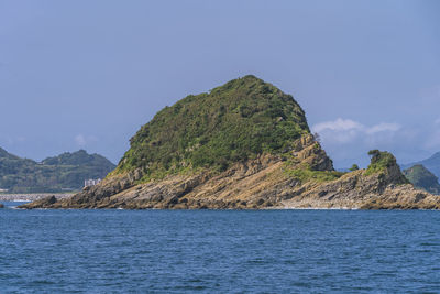 Scenic view of sea and mountains against sky