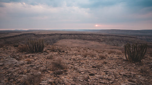 Scenic view of landscape against sky during sunset