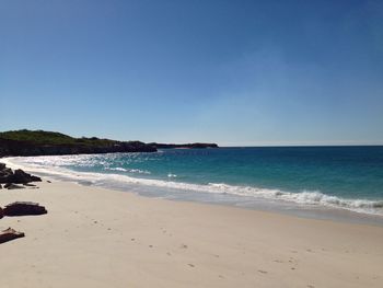 Scenic view of beach against clear sky