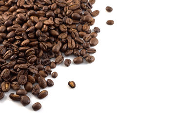High angle view of coffee beans against white background