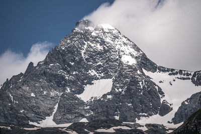 Low angle view of snowcapped mountain against sky