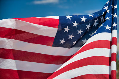 Low angle view of flag flags against blue sky