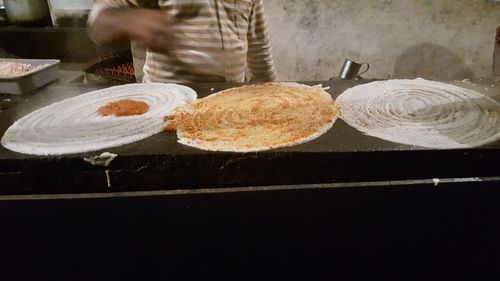 Close-up of person preparing food in kitchen