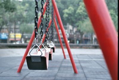 Close-up of padlocks hanging on metal chain