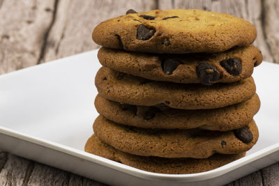 Freshly made chocolate chip cookies on a plate.