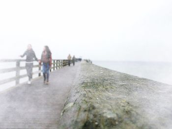 Pier on sea against clear sky