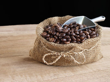 Close-up of bread on table against black background