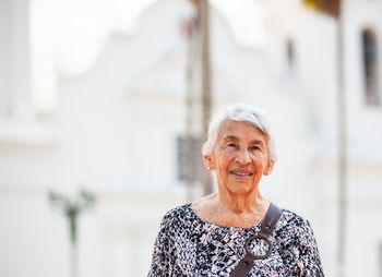 Senior adult woman at the central square in the city of guaduas. senior travel concept.