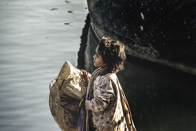 Side view of woman looking at lake