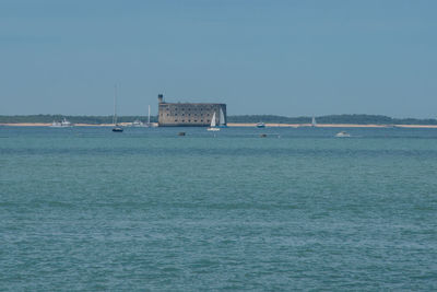 Scenic view of sea against clear blue sky