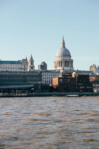 St paul cathedral at golden hour from across the river thames in london.