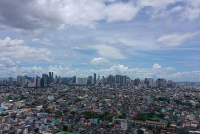 Aerial view of modern buildings in city against sky