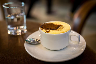 Close-up of served coffee cup on table