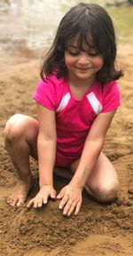 Cute girl sitting on beach