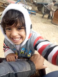 Portrait of smiling boy sitting outdoors