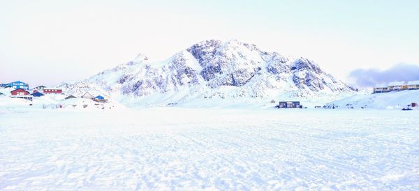 Scenic view of snow covered mountains against sky