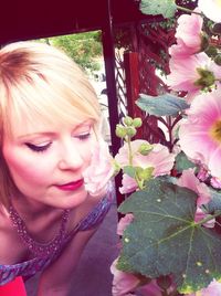 Portrait of cute girl holding pink flower