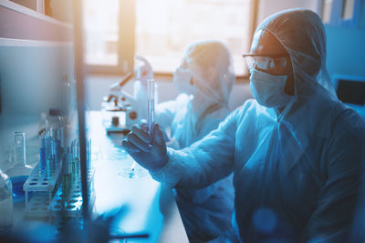 Midsection of man working in laboratory