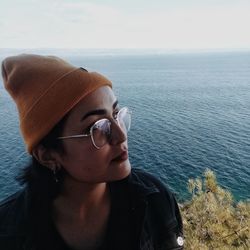 Portrait of man wearing sunglasses against sea