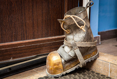 Close-up of old shoes hanging on wall