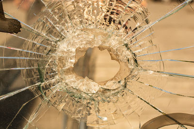 Close-up of broken glass window